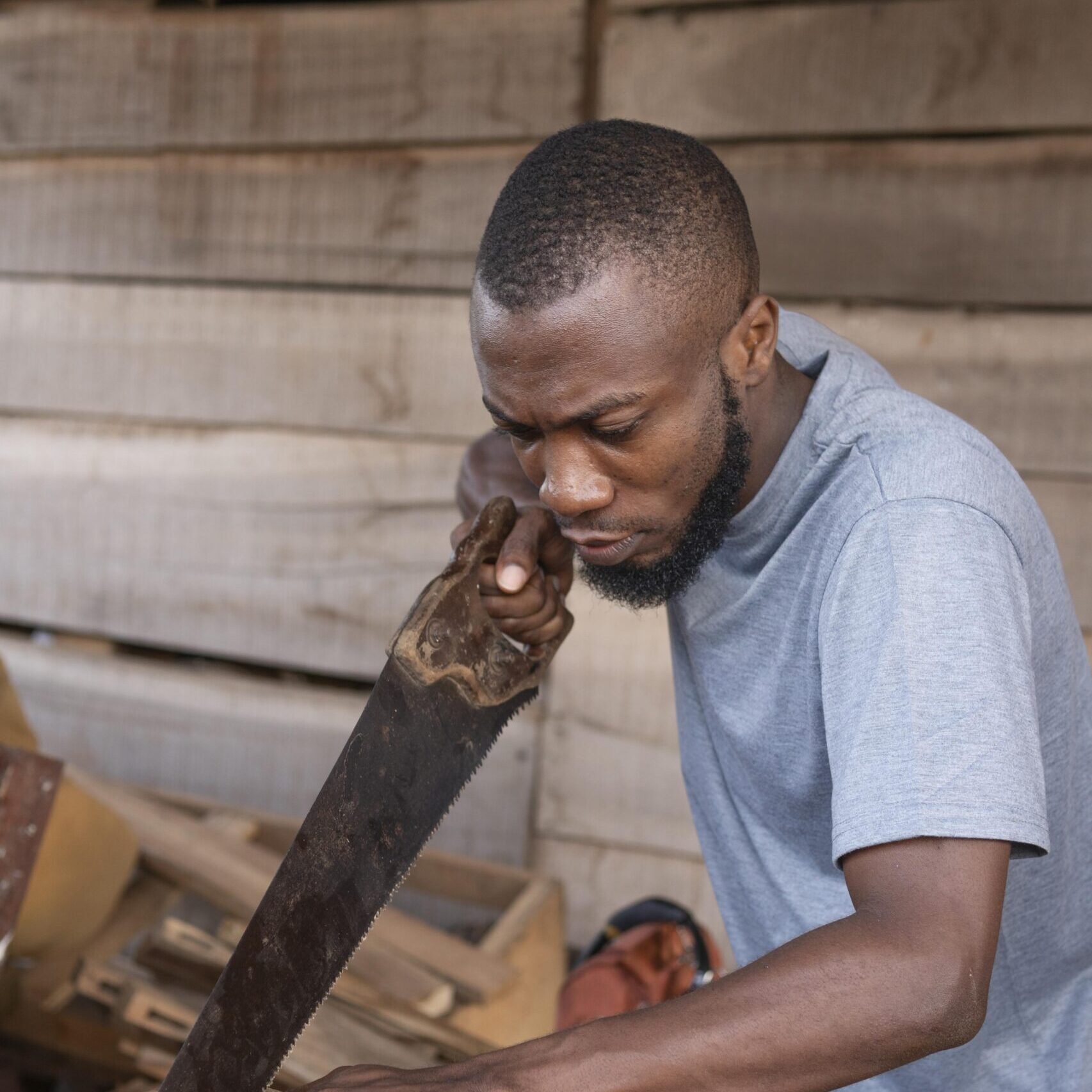 medium-shot-man-working-with-hand-saw